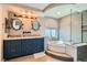 Luxurious bathroom with double sinks, soaking tub, and stylish walk-in shower behind glass panel at 20 High Sierra Dr, Henderson, NV 89074