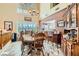 Elegant dining room with a wooden table, large windows, and a decorative chandelier at 20 High Sierra Dr, Henderson, NV 89074