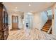 Foyer with wood-look flooring, staircase, and decorative front door at 20 High Sierra Dr, Henderson, NV 89074
