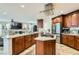 Well-equipped kitchen featuring stainless steel appliances, a kitchen island, and hardwood floors at 20 High Sierra Dr, Henderson, NV 89074