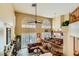 Spacious living room with large windows, a ceiling fan, and an open layout to the dining area at 20 High Sierra Dr, Henderson, NV 89074