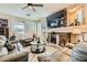 Cozy living room features a stone fireplace and large windows with plantation shutters at 20 High Sierra Dr, Henderson, NV 89074