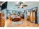 Cozy main bedroom with wood floors, a ceiling fan, and warm natural light at 20 High Sierra Dr, Henderson, NV 89074