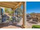 Spacious covered patio, ideal for outdoor dining and entertaining, with a built-in grill and views of the landscaped backyard at 20 High Sierra Dr, Henderson, NV 89074