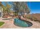 Backyard pool with rock waterfall feature and lush landscaping creates a private outdoor oasis at 20 High Sierra Dr, Henderson, NV 89074