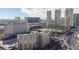 Aerial view of the building, showcasing proximity to a golf course, city buildings, and palm trees at 205 E Harmon Ave # 707, Las Vegas, NV 89169