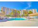 Inviting outdoor pool and lounge area with mature landscaping and beautiful surrounding building at 205 E Harmon Ave # 707, Las Vegas, NV 89169