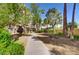 Landscaped walkway with mature trees and flowerbeds, providing a serene pathway around the building at 205 E Harmon Ave # 707, Las Vegas, NV 89169