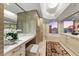A modern bathroom with a large mirror, vanity area, and bathtub, creating a spa-like retreat at 222 Karen Ave # 3908, Las Vegas, NV 89109