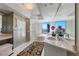 Modern bathroom features a soaking tub, glass shower, and dual sinks with a city view at 222 Karen Ave # 3908, Las Vegas, NV 89109