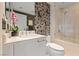 Elegant bathroom featuring stylish wallpaper, a modern vanity, and a glass-enclosed shower at 222 Karen Ave # 3908, Las Vegas, NV 89109