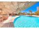 Outdoor pool and hot tub viewed from under a decorative rock overhang at 222 Karen Ave # 3908, Las Vegas, NV 89109