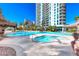 Outdoor pools, hot tub, and surrounding landscaped areas on a sunny day at 222 Karen Ave # 3908, Las Vegas, NV 89109