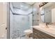 Updated bathroom with glass enclosed shower, a modern vanity and pebble floor at 2836 Floral Peak Dr, Henderson, NV 89074