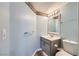 Powder room featuring a single sink vanity, a decorative mirror and blue walls at 2836 Floral Peak Dr, Henderson, NV 89074