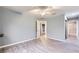Bedroom with light gray walls, wood-look floors, ceiling fan, and ensuite bathroom access at 2836 Floral Peak Dr, Henderson, NV 89074