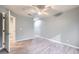 Spacious bedroom with plank flooring, a ceiling fan and access to another room at 2836 Floral Peak Dr, Henderson, NV 89074