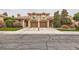 Two story townhome featuring a two-car garage, well-manicured lawn, and desert landscaping at 2836 Floral Peak Dr, Henderson, NV 89074
