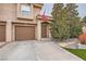 Well-kept home featuring a two-car garage, manicured lawn, and charming front entrance at 2836 Floral Peak Dr, Henderson, NV 89074