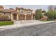 Inviting townhouse with a two-car garage, well-maintained landscaping, and neutral color palette at 2836 Floral Peak Dr, Henderson, NV 89074
