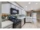 Modern kitchen featuring stainless steel appliances, gray cabinets, and beautiful backsplash at 2836 Floral Peak Dr, Henderson, NV 89074