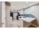Modern kitchen featuring stainless steel appliances, a breakfast bar, and mosaic tile backsplash at 2836 Floral Peak Dr, Henderson, NV 89074