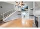 Bright living room featuring hardwood floors, a staircase, and a ceiling fan at 2836 Floral Peak Dr, Henderson, NV 89074