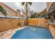 Private patio with custom bar, tv, wood fence, desert landscaping, and sliding door access at 2836 Floral Peak Dr, Henderson, NV 89074