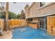 Private patio with custom bar, tv, wood fence, and desert landscaping at 2836 Floral Peak Dr, Henderson, NV 89074
