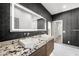 Modern bathroom features a dual sink vanity, an illuminated mirror, and modern finishes at 2861 Queens Courtyard Dr, Las Vegas, NV 89109
