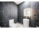 Chic powder room featuring patterned wallpaper, unique pedestal sink, and modern lighting at 2861 Queens Courtyard Dr, Las Vegas, NV 89109