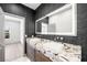 Modern bathroom featuring a granite dual sink vanity and an illuminated mirror at 2861 Queens Courtyard Dr, Las Vegas, NV 89109