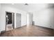 A bright bedroom features hardwood floors, fresh white paint, and access to the bathroom at 2861 Queens Courtyard Dr, Las Vegas, NV 89109