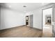 A bright bedroom features hardwood floors, fresh white paint, and ensuite bathroom access at 2861 Queens Courtyard Dr, Las Vegas, NV 89109
