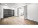 Bedroom with wood floors, a large closet, and a doorway leading to another room at 2861 Queens Courtyard Dr, Las Vegas, NV 89109