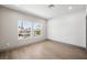 Bright bedroom with hardwood flooring and views of the outdoors from two large windows at 2861 Queens Courtyard Dr, Las Vegas, NV 89109