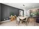 Stylish dining room boasts a modern light fixture, textured accent wall, and hardwood floors at 2861 Queens Courtyard Dr, Las Vegas, NV 89109