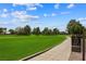 A view of the lush green golf course on a sunny day with blue skies and white clouds at 2861 Queens Courtyard Dr, Las Vegas, NV 89109