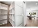 Bright hallway with built-in shelving and access to the dining area with views of the backyard pool at 2861 Queens Courtyard Dr, Las Vegas, NV 89109