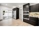 Sleek kitchen featuring stainless steel appliances, dark cabinetry, and stone countertops at 2861 Queens Courtyard Dr, Las Vegas, NV 89109