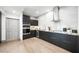 Modern kitchen with stainless steel appliances, dark cabinetry, and stone countertops at 2861 Queens Courtyard Dr, Las Vegas, NV 89109