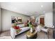 Bright living room featuring hardwood floors, a modern staircase, and stylish furniture at 2861 Queens Courtyard Dr, Las Vegas, NV 89109