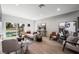 Sun-lit living room with wood floors, neutral decor, and backyard pool view at 2861 Queens Courtyard Dr, Las Vegas, NV 89109