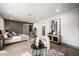 Cozy main bedroom with a sitting area, modern decor, and a sliding door leading to the bathroom at 2861 Queens Courtyard Dr, Las Vegas, NV 89109