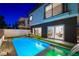 Backyard pool at twilight with modern design, lush landscaping, and exterior views at 2861 Queens Courtyard Dr, Las Vegas, NV 89109