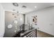 Bright staircase with a modern chandelier, black metal railing, and natural light from the windows at 2861 Queens Courtyard Dr, Las Vegas, NV 89109