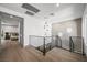 Upstairs landing featuring a modern chandelier, wood floors, and access to a bedroom at 2861 Queens Courtyard Dr, Las Vegas, NV 89109