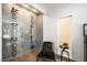 Modern wine cellar with glass enclosure, wine rack, and natural light from window at 2861 Queens Courtyard Dr, Las Vegas, NV 89109