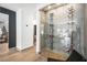 Contemporary wine cellar featuring a glass enclosure and sleek wine racks at 2861 Queens Courtyard Dr, Las Vegas, NV 89109