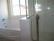 Modern bathroom with a soaking tub, separate shower and large window at 3104 Naggio Shores Ave, Las Vegas, NV 89141
